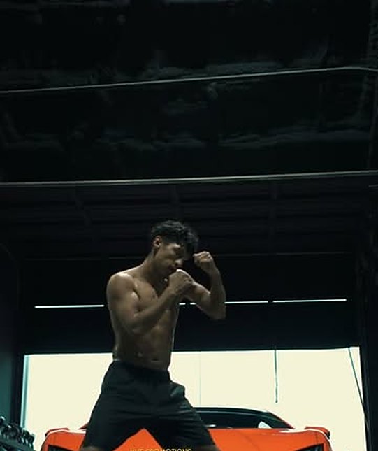 Boxer shadowboxing in a warehouse gym