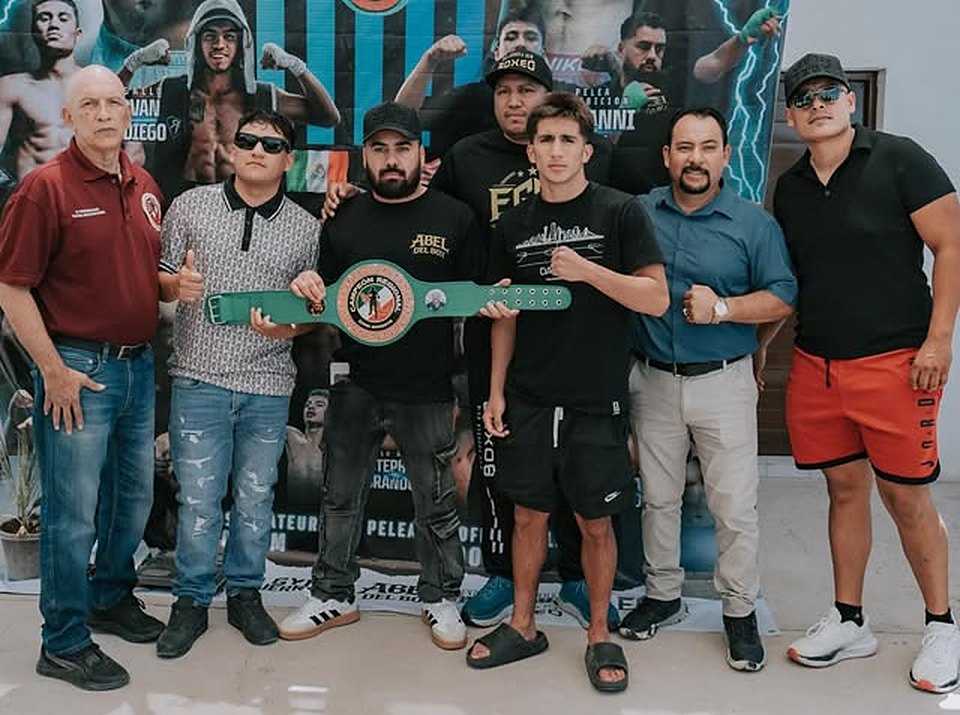 EGBG coaches and fighters holding a championship belt